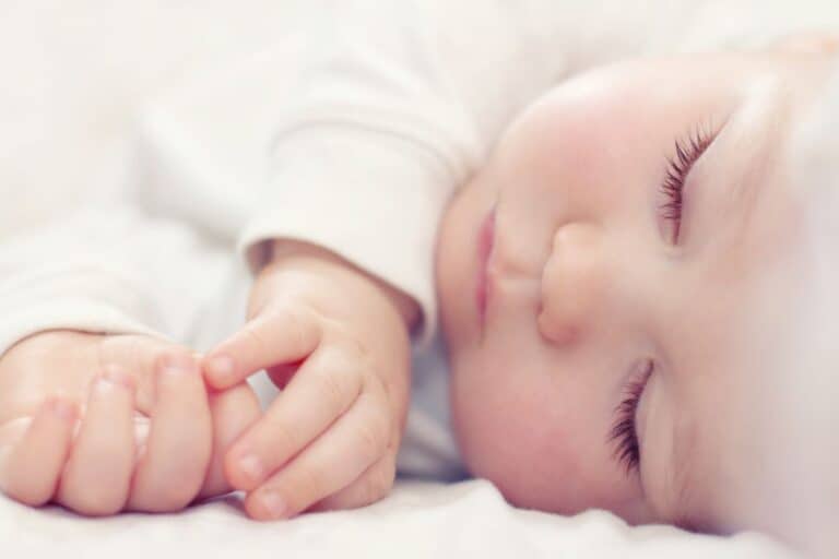 Baby sleeping soundly in crib.