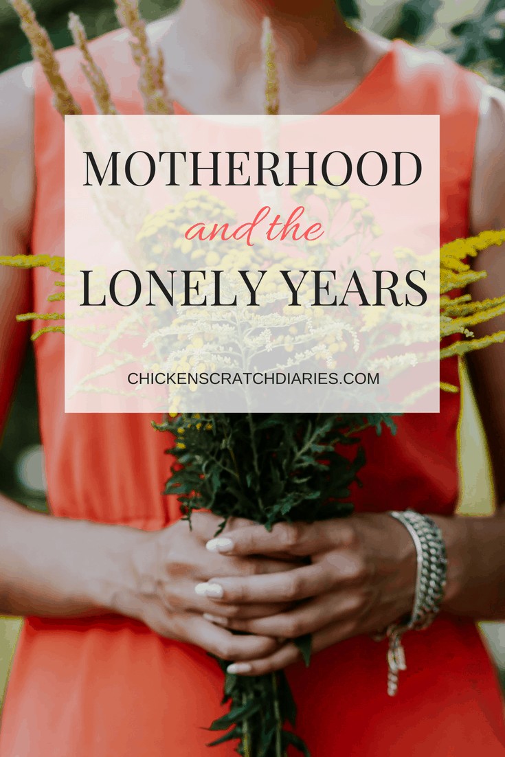 Image of woman in sundress holding bright yellow bouquet outdoors with text: "Motherhood and the Lonely Years"