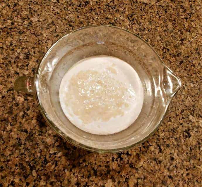 Yeast blooming in a glass mixing bowl.