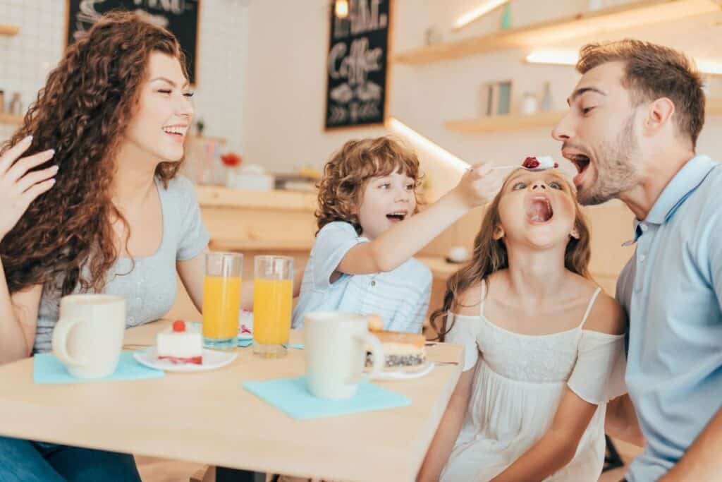 Happy family eating excitedly at a restaurant together