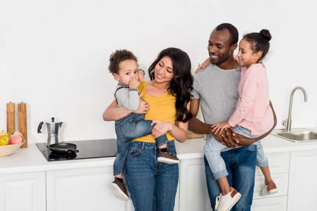 Happy family of four in kitchen