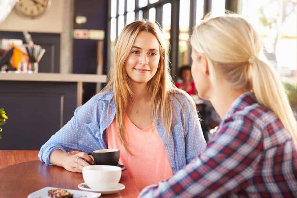 Two friends talking over coffee.