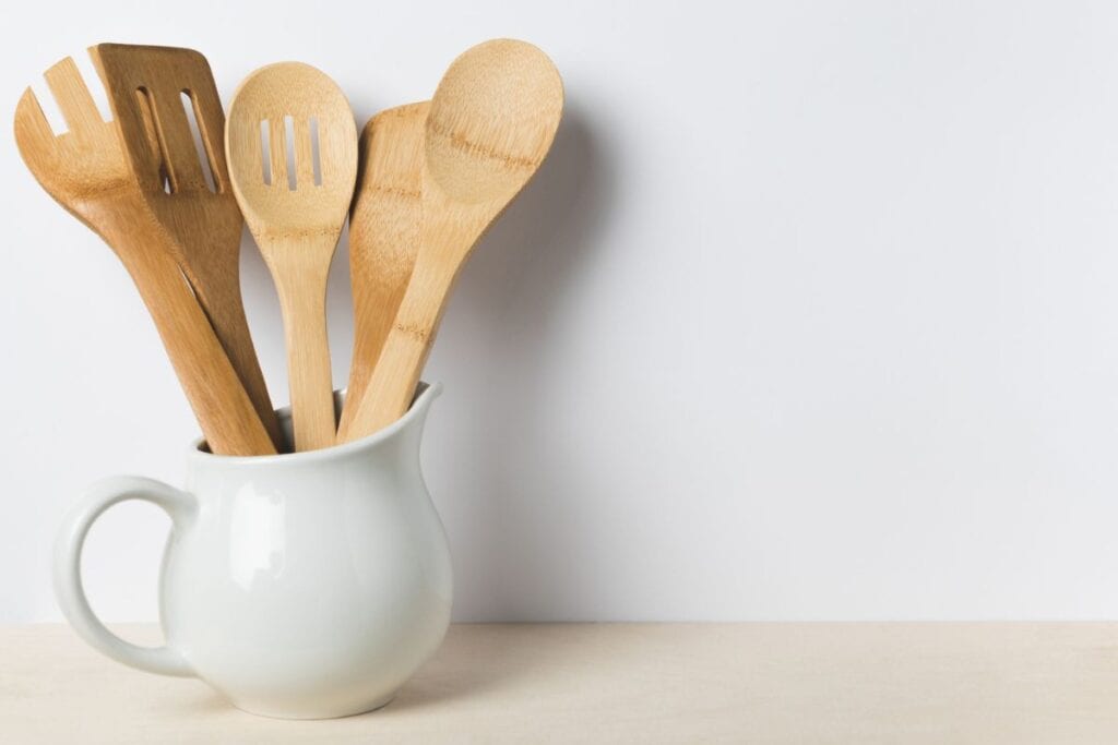 Kitchen utensils in a white pitcher-crockpot freezer meals featured