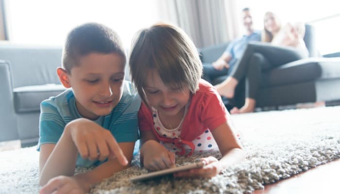 Teaching Kids Respect in a Positive Way - Sharing or Not Sharing; example of two kids sharing a game in the living room floor.
