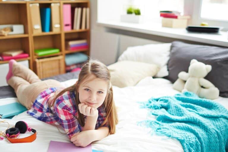 Girl lying on bed in messy room