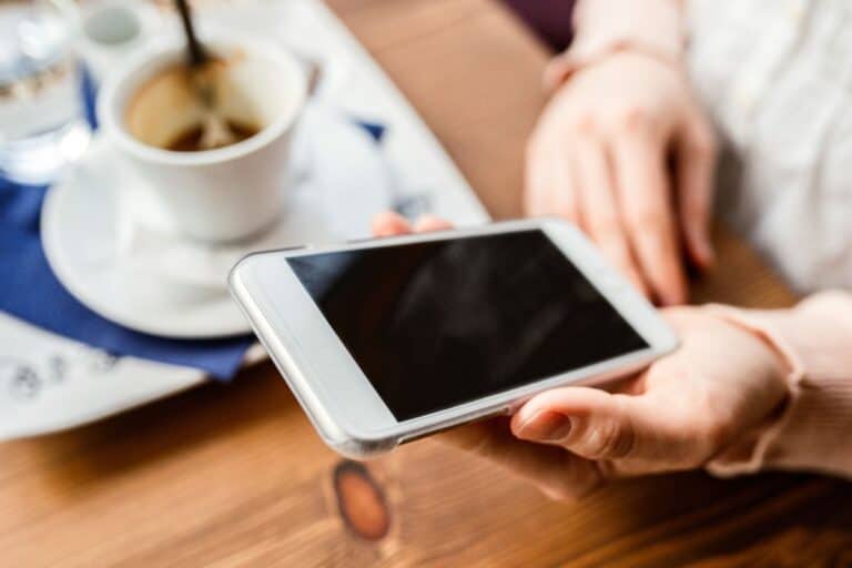 Woman on smartphone while waiting at restaurant