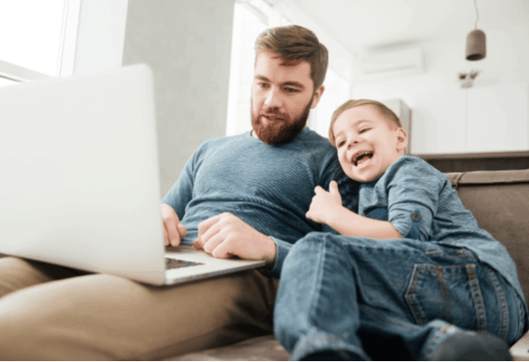 YouTube Alternatives for Kids- father and son watching a laptop at home together, laughing.