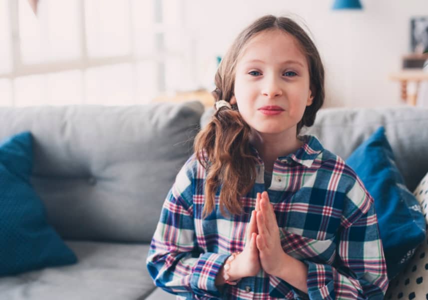 curbing overindulgence: a preteen girl with hands together in "please" gesture- asking for more.