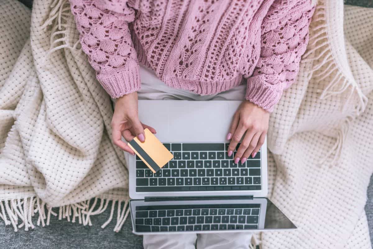 woman with credit card ordering supplies on amazon on her laptop.