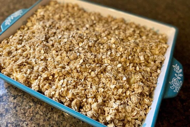 Finished apple crisp recipe in large stoneware baker.