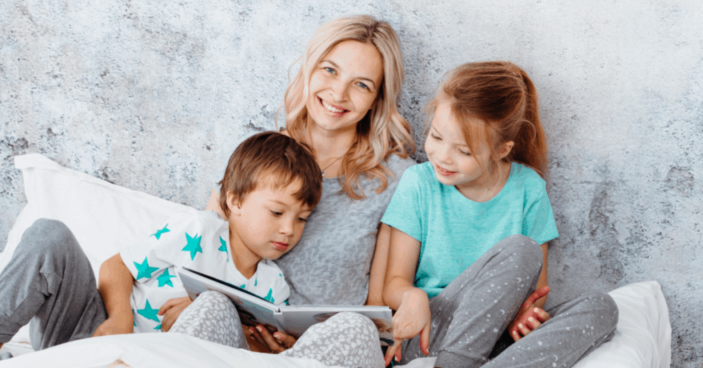 Mom reading books on values to kids at bedtime