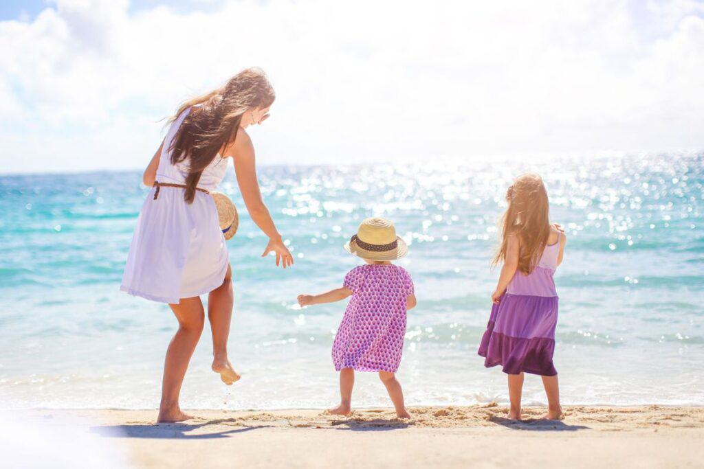 mom and daughters playing at the beach. Trusting God with our kids.