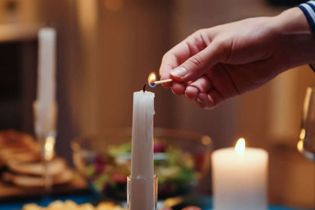 Lighting candles at Christmas Eve dinner