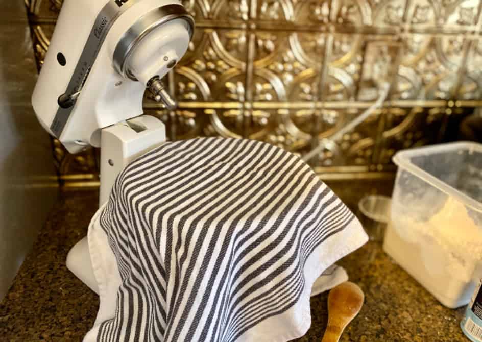 crusty french bread recipe-step 5: Letting dough rise, covered with a tea towel in bowl.