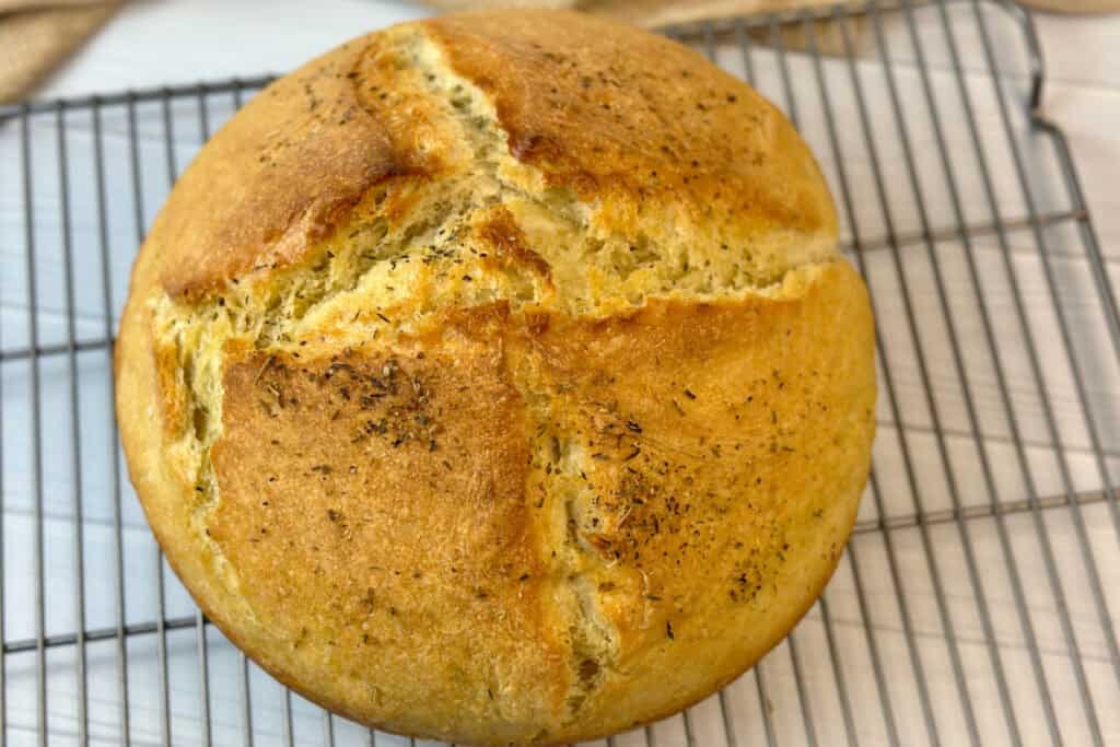 Top view of crusty round loaf of bread ready to slice.