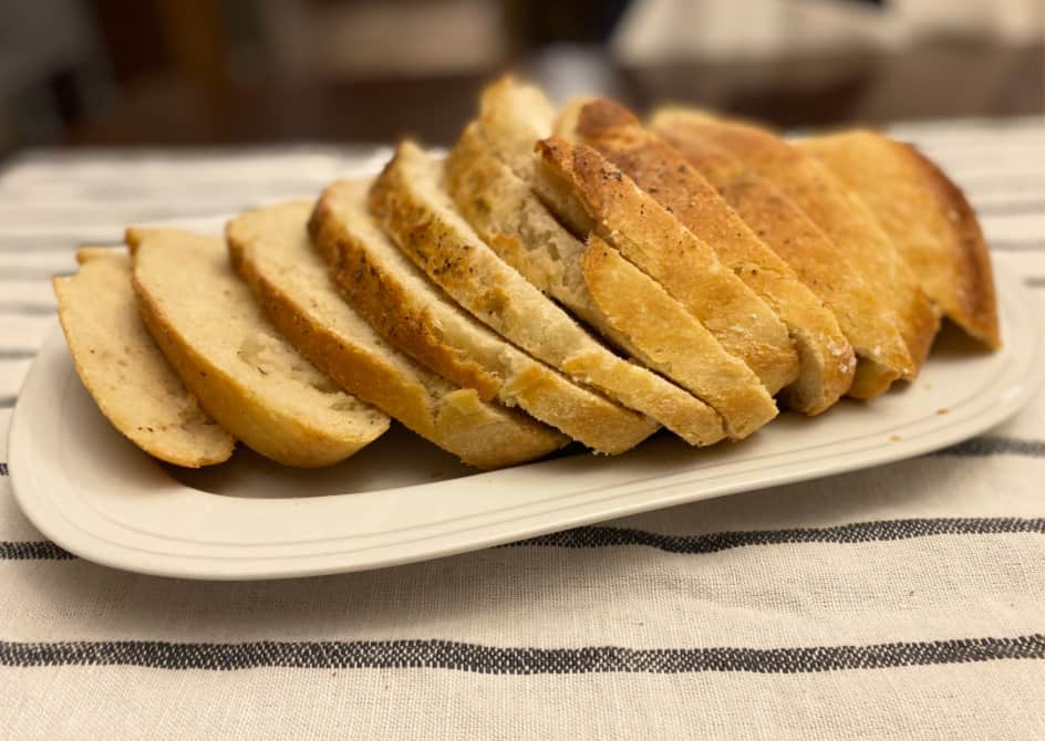 french bread sliced on a white platter --finished product