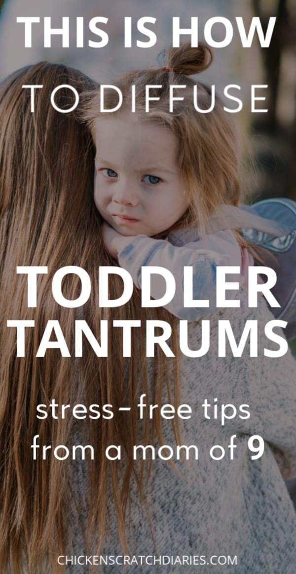 Graphic of toddler being held by mom with text "This is how to diffuse toddler tantrums- stress free tips from a mom of 9"