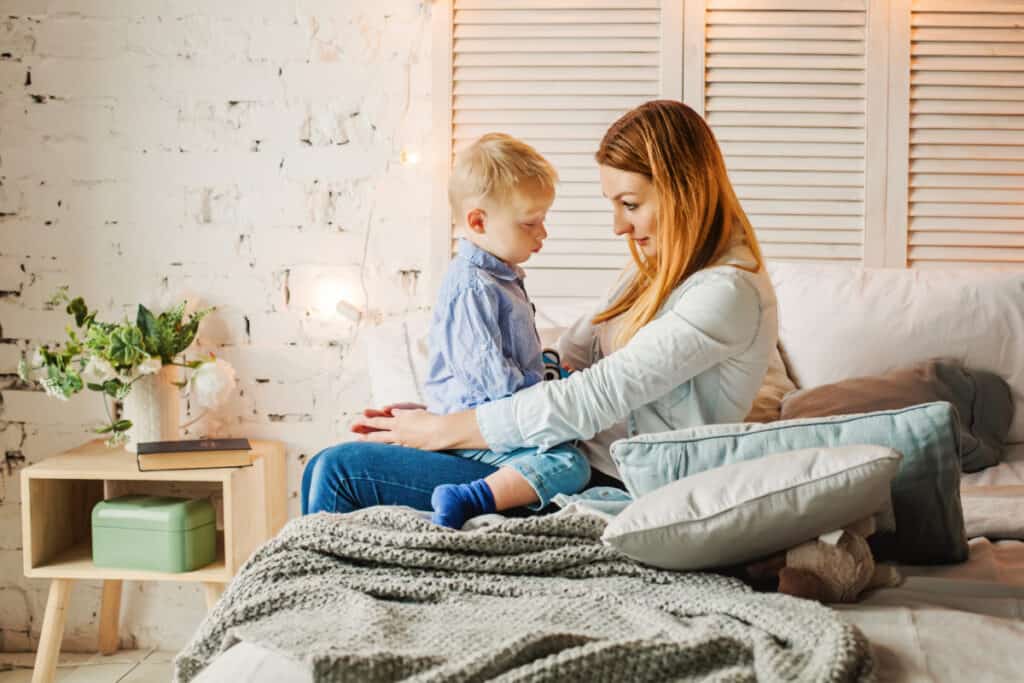 mom sitting with toddler boy.