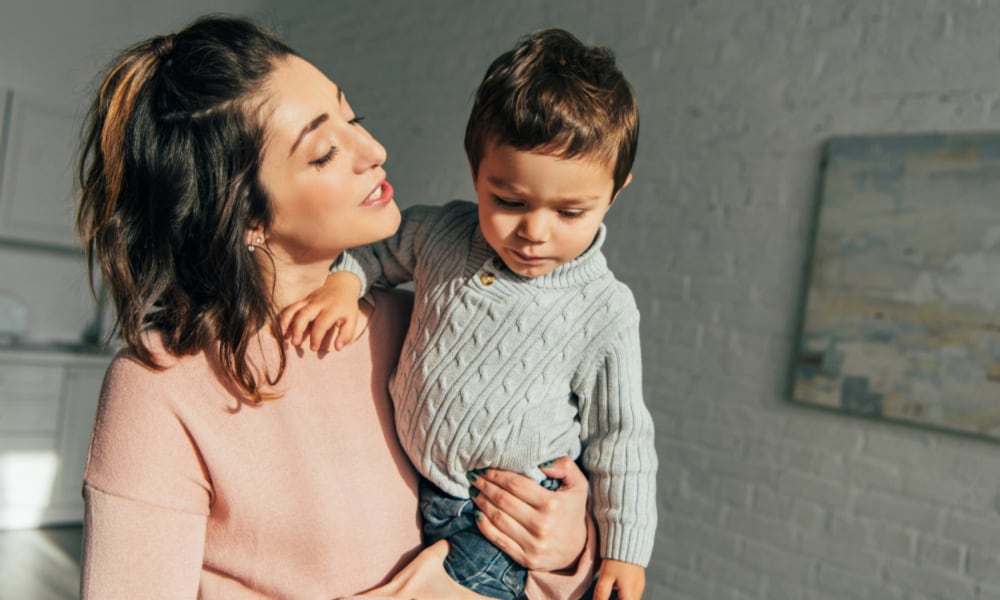 Mom holding toddler son. Concept of diffusing one year old, two year old, three year old tantrums