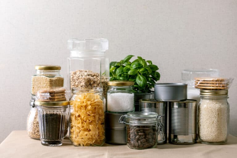non perishable pantry foods in glass jars and tin cans.