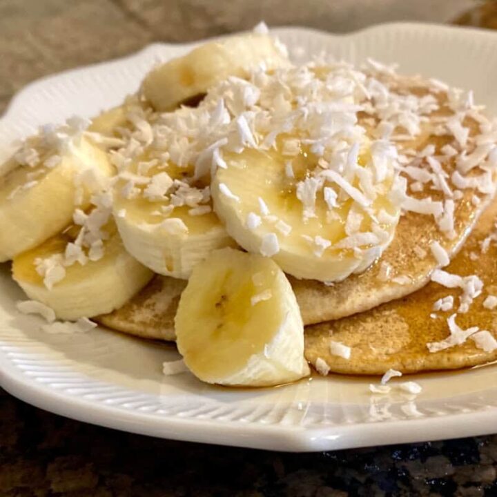 pancakes made with oat flour on a plate with toppings.