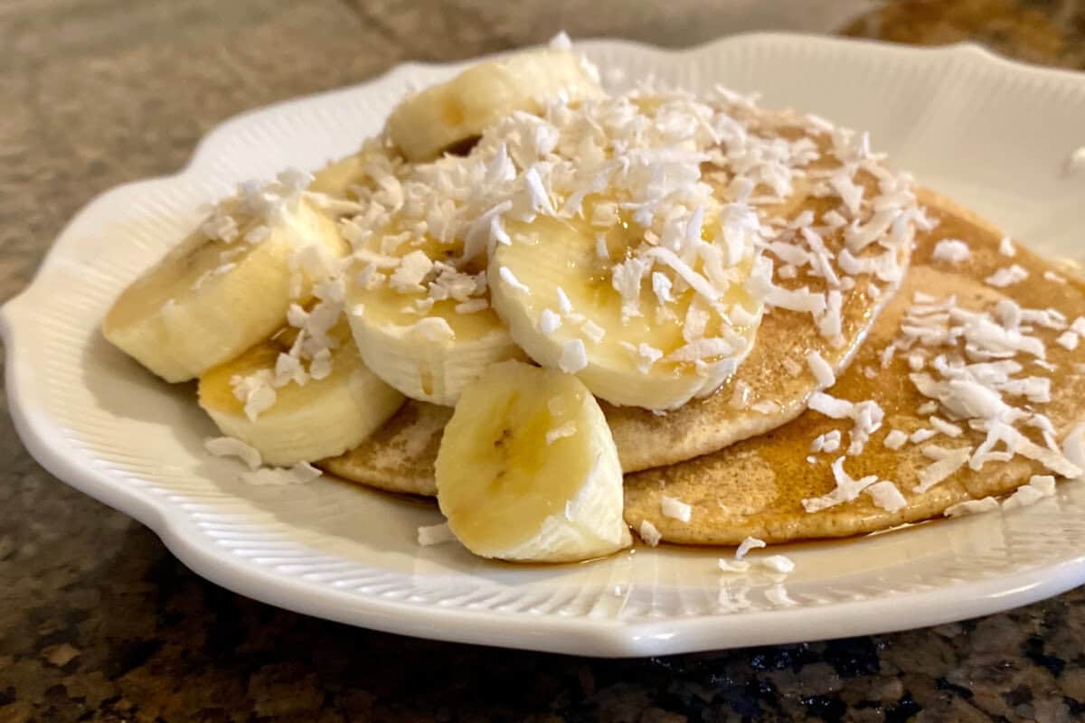 pancakes made with oat flour on a plate with toppings.