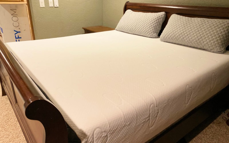 Our puffy mattress after purchase. Set up on a wooden frame with a box spring underneath and with Puffy King Size pillows on top.