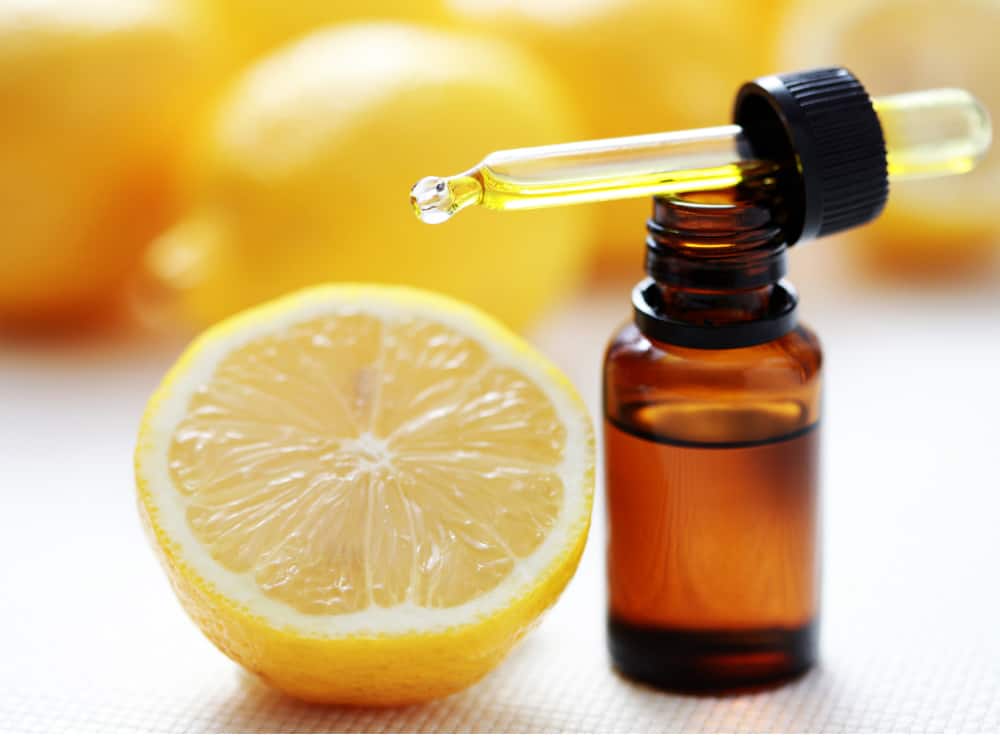 fresh lemon and bottle of lemon oil