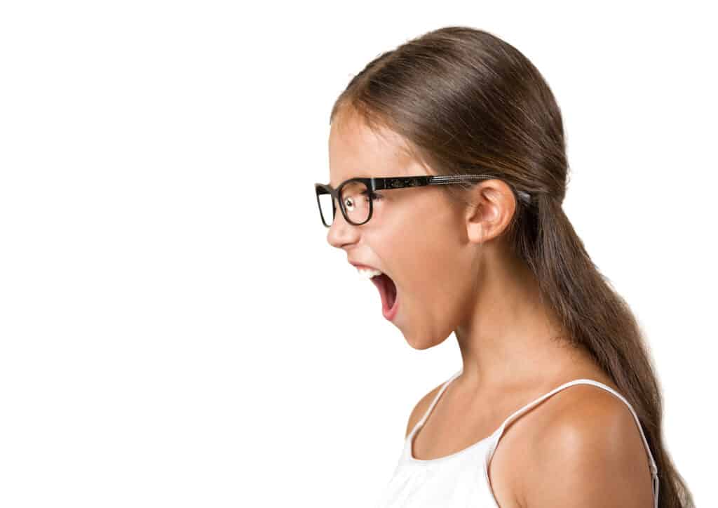 Girl against a white background, shouting; concept of deciding appropriate punishment for talking back-tips and reminders