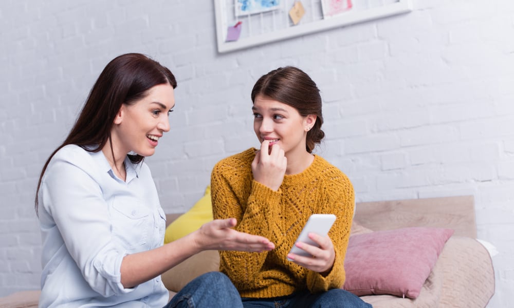 mom with teen daughter discussing music preferences