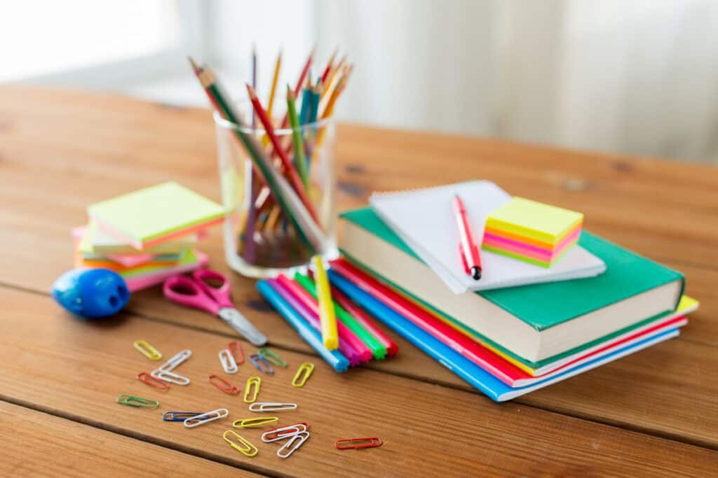 School supplies arranged on a wooden table.