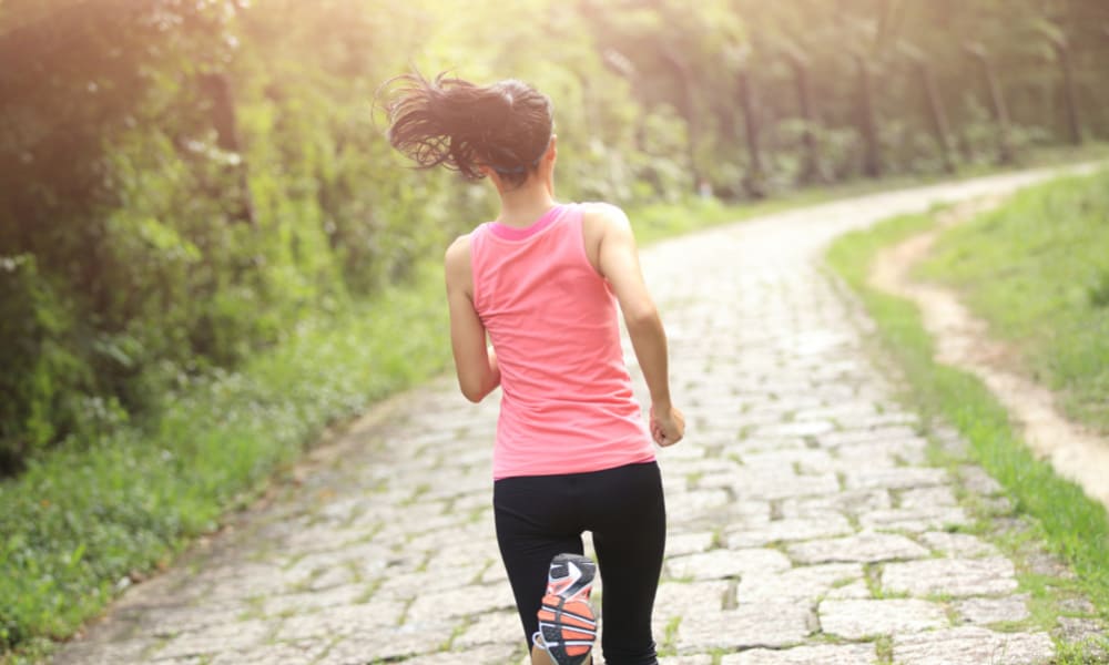 hobbies for moms: a woman running down a cobbled trail.