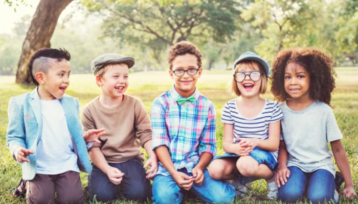 Concept of how to explain respect to a child; image of children of various races and abilities having fun together outdoors.