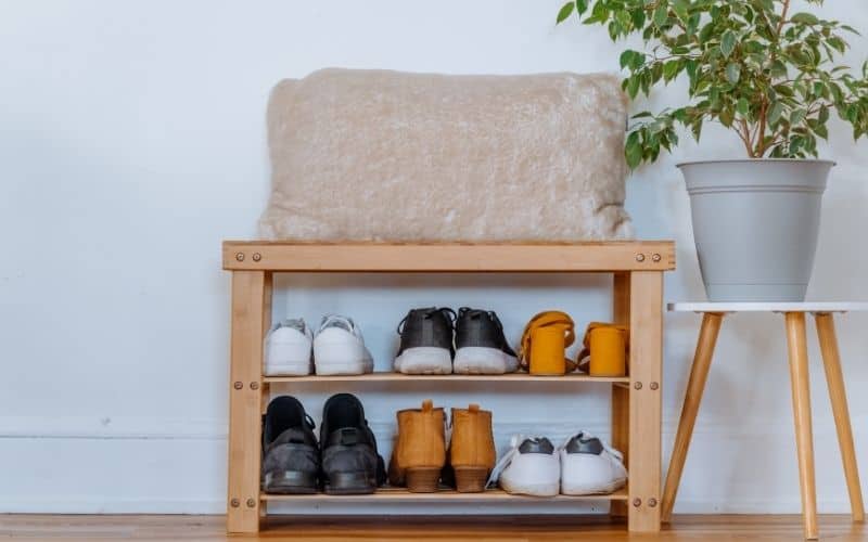 image of teaching kids to put away belongings- a shoe organizer by the front door keeps the entryway tidy.