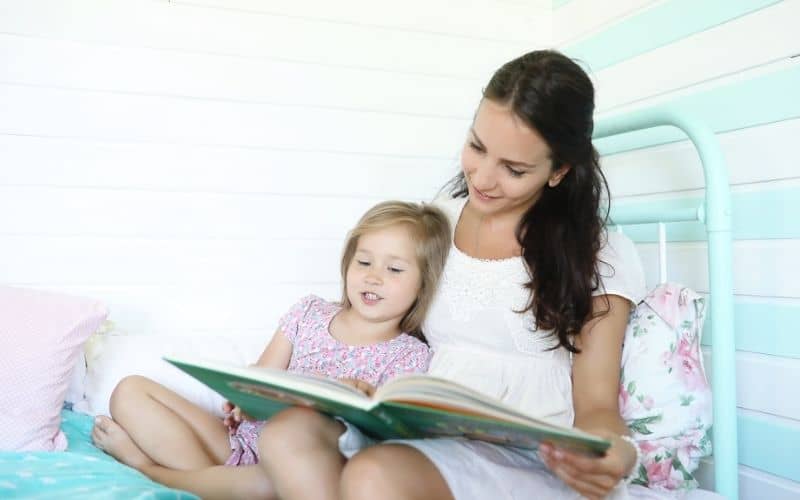 making kids responsible for their time-image of mom reading bedtime books when chores are completed.