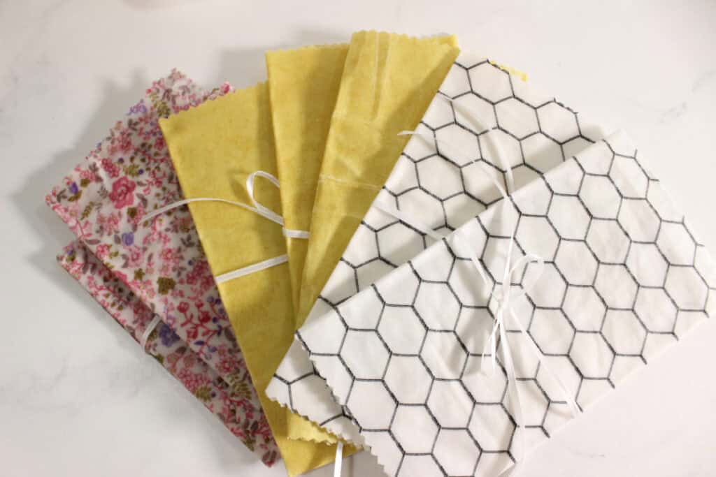 Various beeswax wraps in colorful fabrics.
