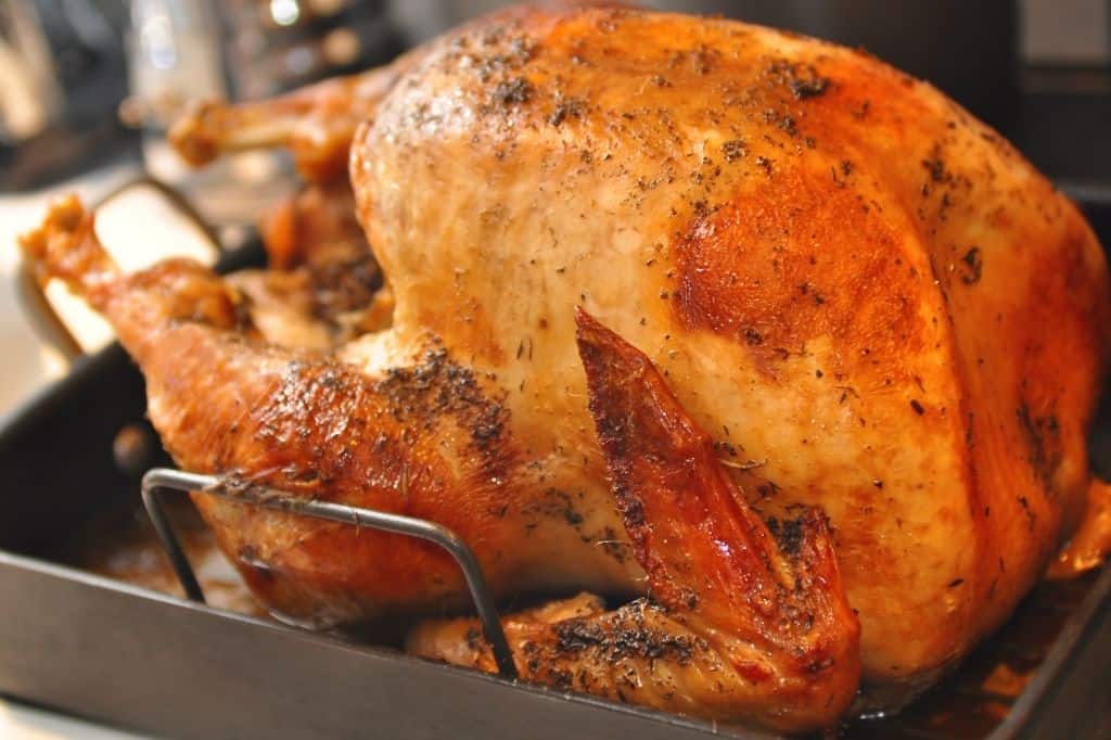 roasted turkey coming out of oven.