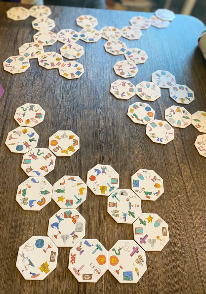 Image of Bible game tiles being played side by side on a table. 