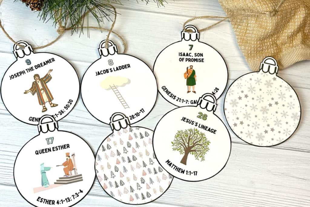 Printed Jesse Tree ornaments on white wood background.
