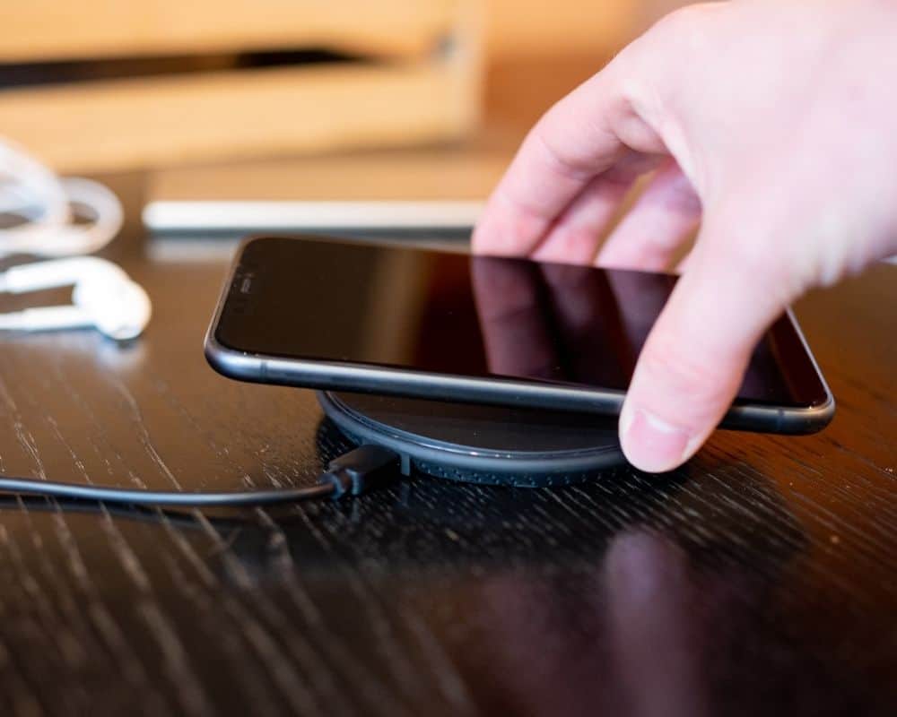 Image of smart phone charging on a table.