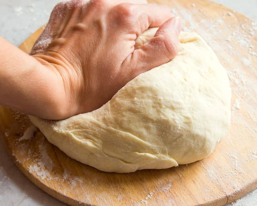 Woman hand kneading dough-demonstration