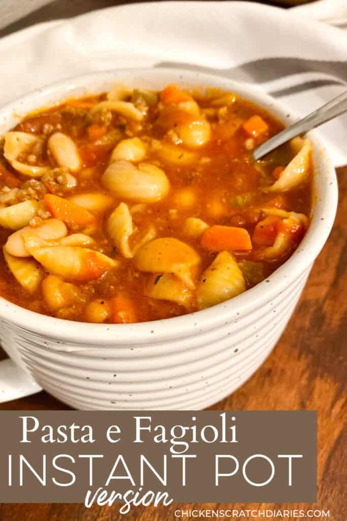 Vertical image of bowl of pasta e fagioli soup in a white ceramic bowl.