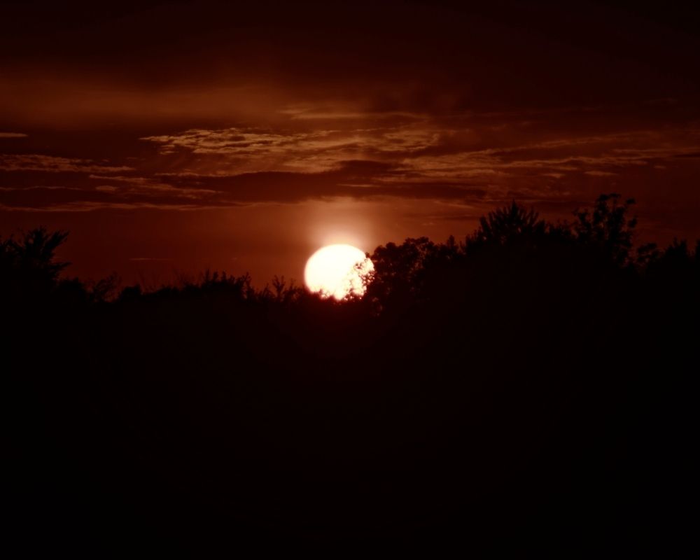 Image of a beautiful sunset with a dark sky. Concept of God's great plan and intention in creation.