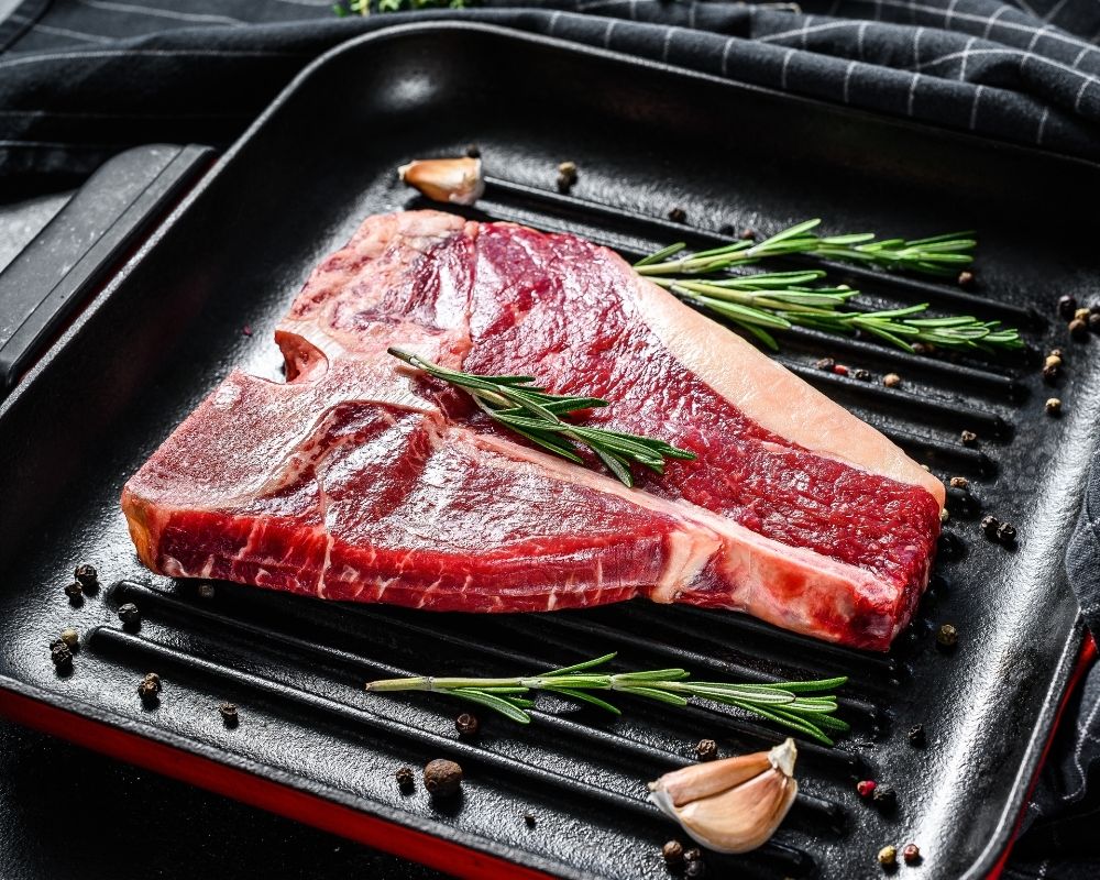 Seasoned steak on a grill pan- concept of buying organic, healthy meat.