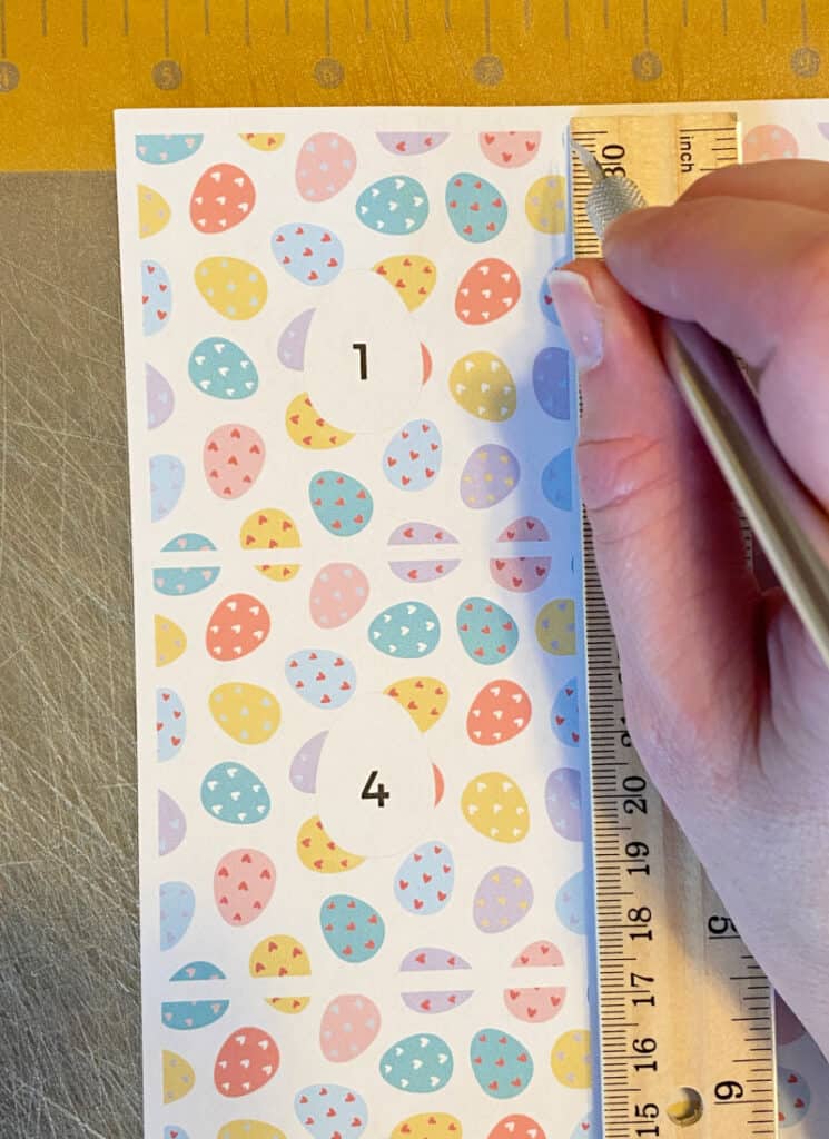 Image of scoring the cardstock, guided by a ruler.