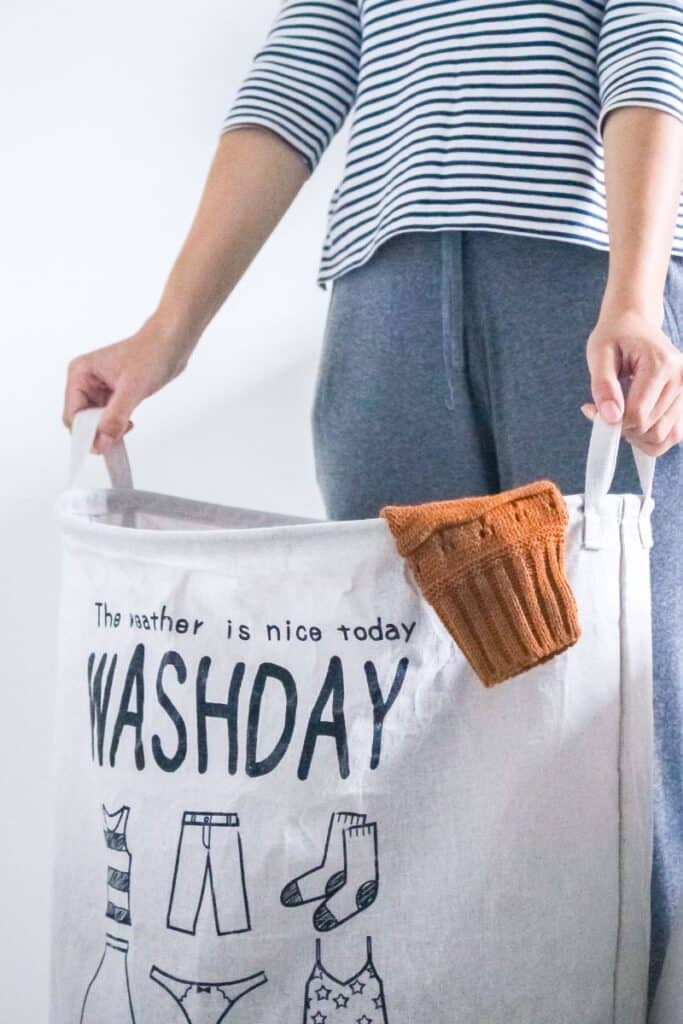 Woman holding a canvas laundry basket