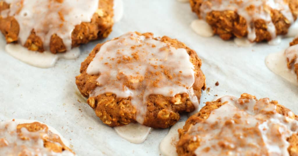 Glazed oatmeal gingerbread cookies on a parchment sheet