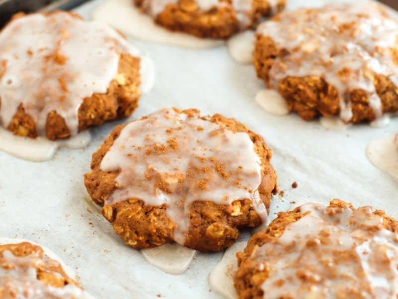 Adding the icing to the oatmeal gingerbread cookies, fresh out of the oven.