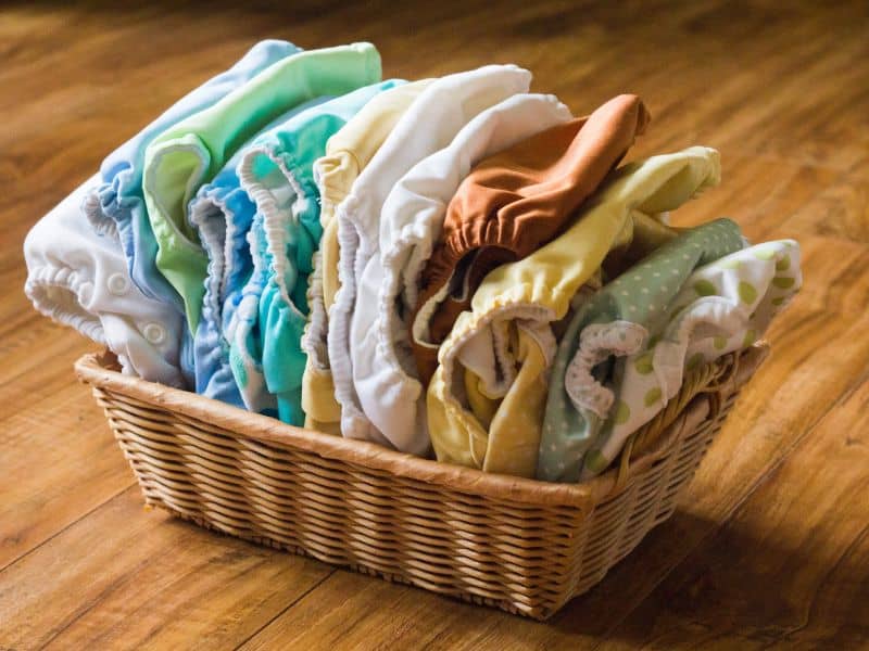 basket of clean cloth diapers in pastel colors.