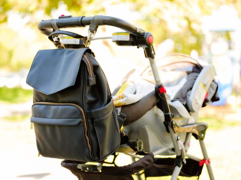 Baby stroller with backpack diaper bag attached; going out with baby and packing cloth diapers.
